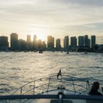 Enjoy a serene boat ride with Miami's iconic skyline at sunset, offering a perfect urban escape.