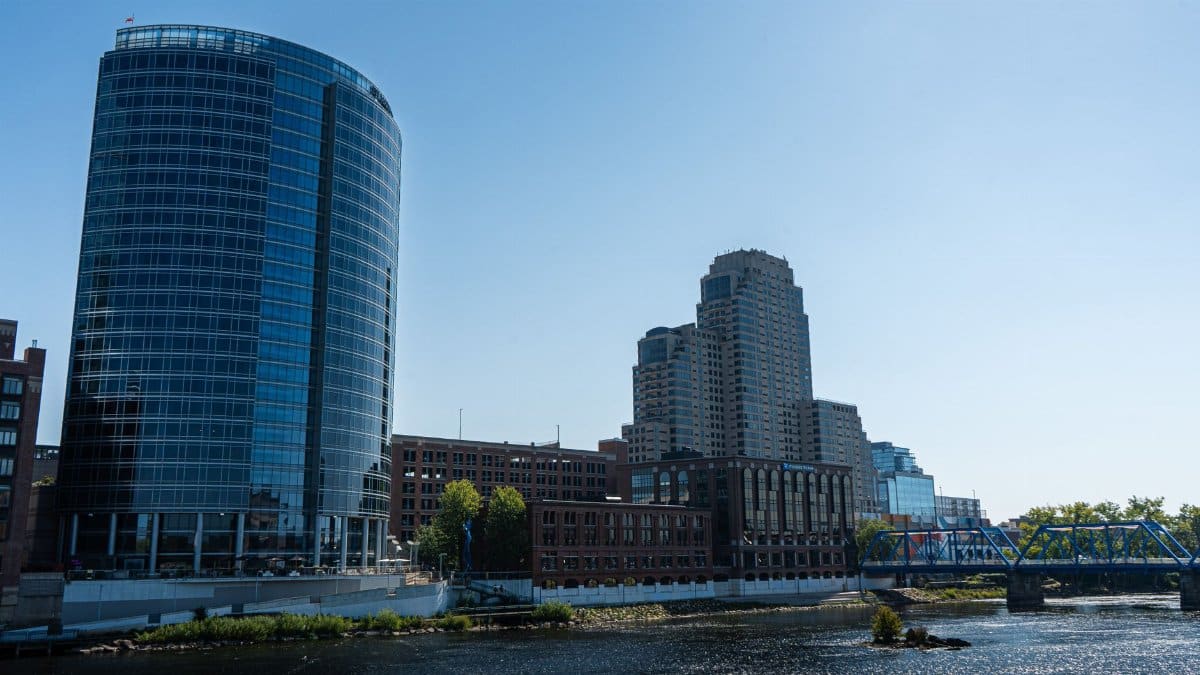 Scenic view of Grand Rapids skyline featuring the iconic Blue Bridge and modern architecture by the Grand River in Michigan.