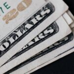 Closeup of USA 20 dollar banknotes placed on black background as national currency for business and personal financial operations