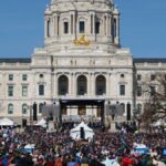 Demonstrators gathered at Minnesota State Capitol advocating for change.