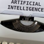 A close-up of a typewriter showcasing 'ARTIFICIAL INTELLIGENCE' on paper.
