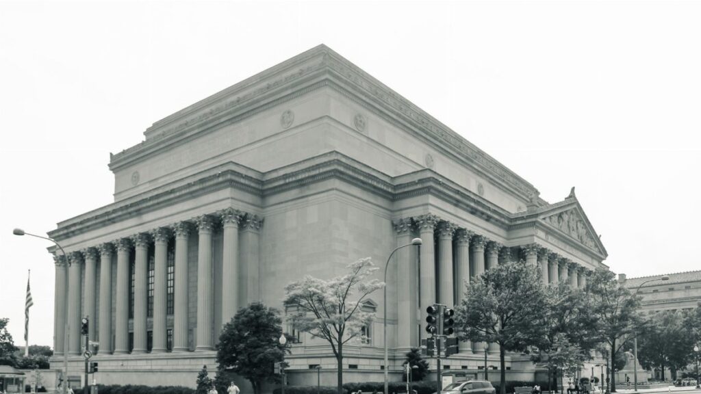 Black and white photo of the National Archives Building in Washington D.C., showcasing its neoclassical architecture.