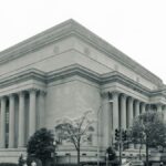 Black and white photo of the National Archives Building in Washington D.C., showcasing its neoclassical architecture.