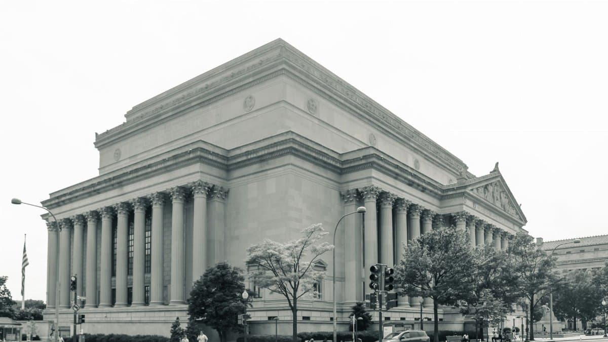 Black and white photo of the National Archives Building in Washington D.C., showcasing its neoclassical architecture.