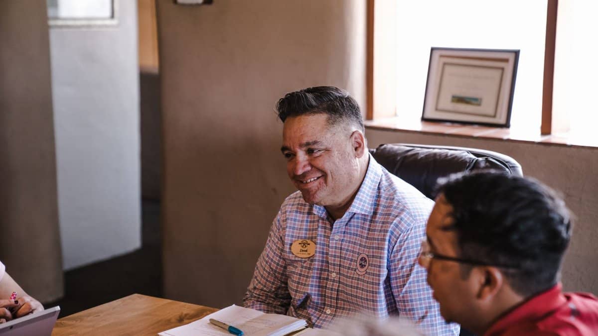 Smiling team members engaging in a positive office discussion.