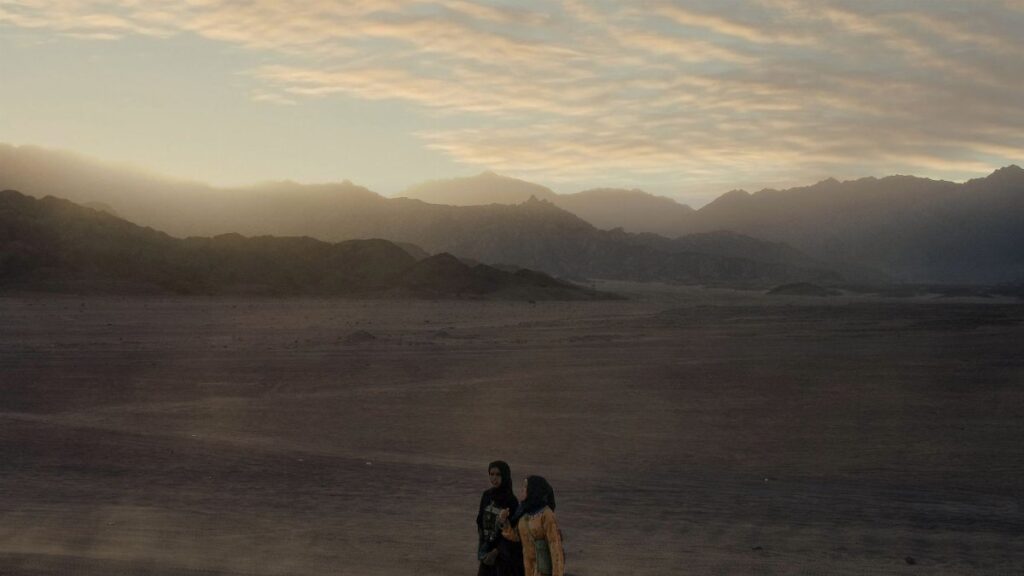 Two women walking at sunset in the majestic Egyptian desert near Sharm El-Sheikh.