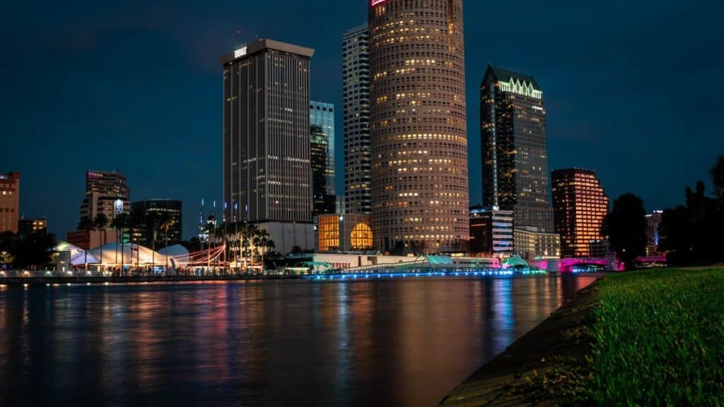 Explore Tampa's stunning evening skyline reflected on the calm river.