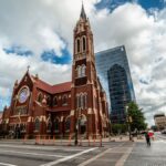 Stunning view of a historic church amid modern Dallas skyline, Texas.