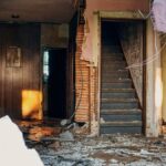 Explore an eerie abandoned interior featuring a crumbling staircase and deteriorating structures in MN, USA.
