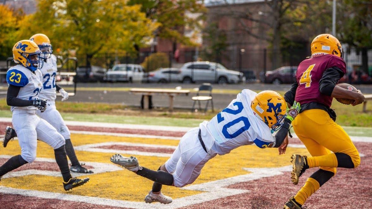 Dynamic tackle during a high school football match in Baltimore.