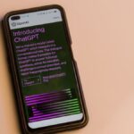 Smartphone screen showing ChatGPT introduction by OpenAI, showcasing AI technology.