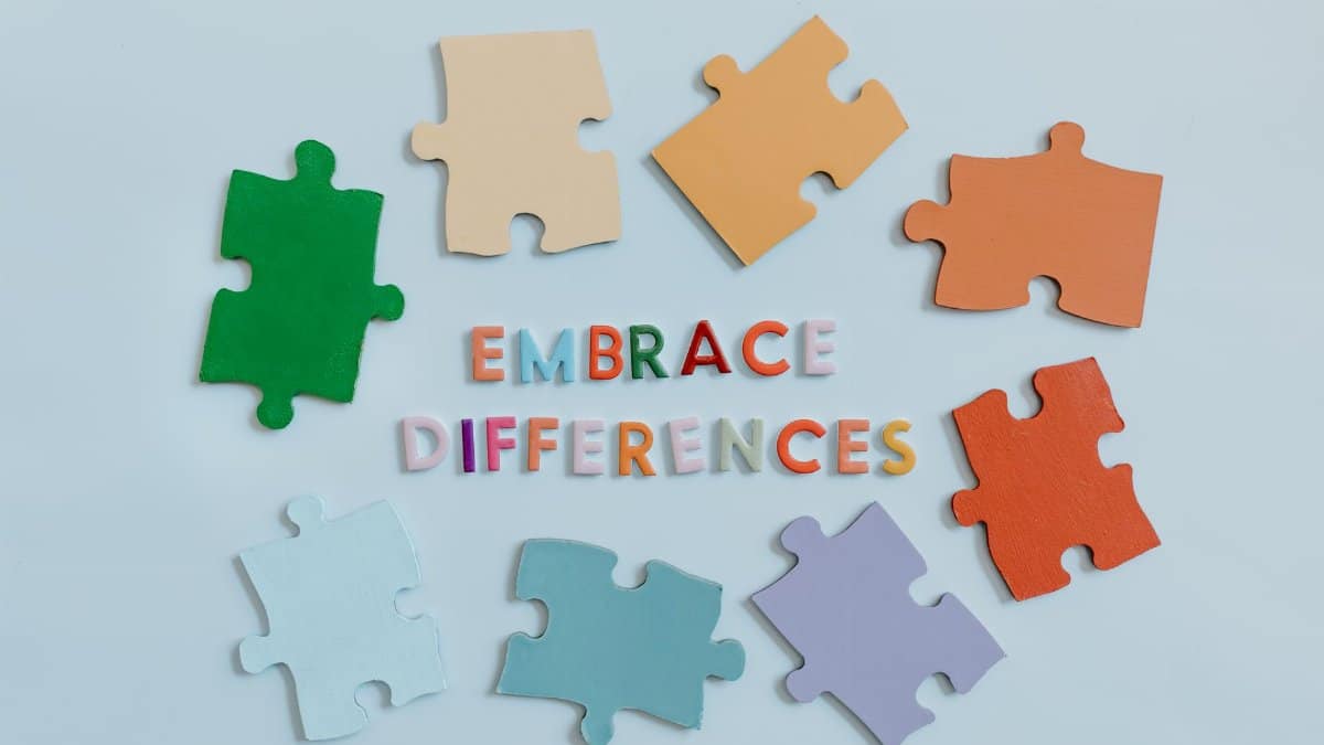 Colorful puzzle pieces surrounding 'embrace differences' text, symbolizing diversity and unity.