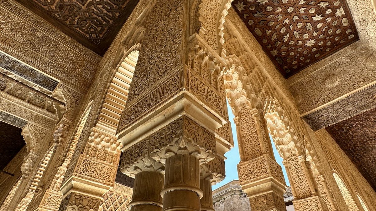 Detailed architectural arches within Alhambra, showcasing Moorish design and craftsmanship in Granada, Spain.