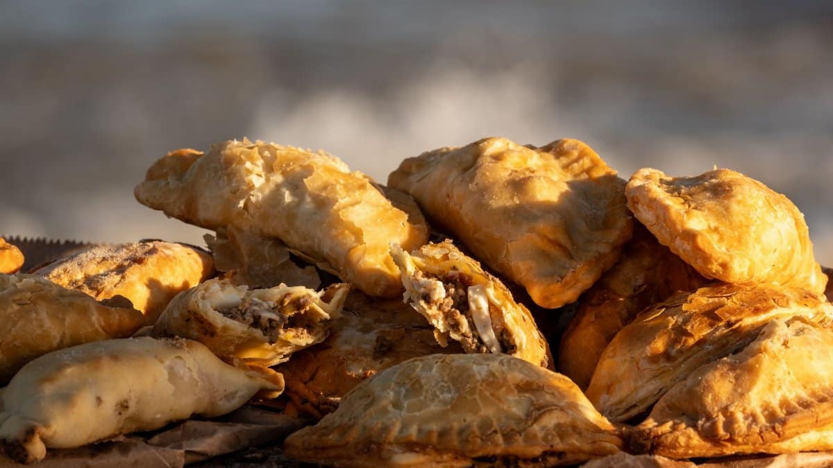 Golden baked empanadas filled with meat, placed by the seaside in Montevideo, Uruguay.