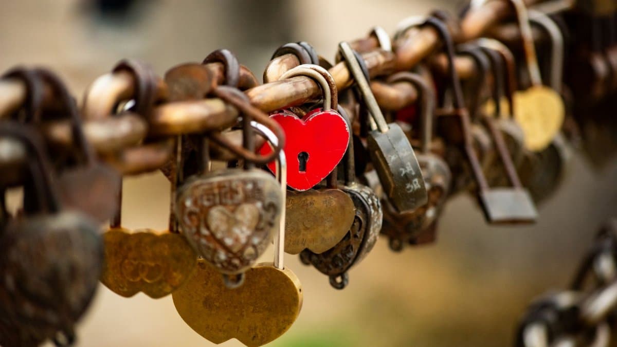 A collection of heart-shaped padlocks on a bridge, symbolizing love and commitment.