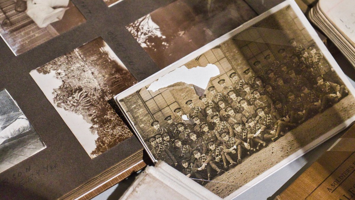 A captivating vintage army photo in a sepia-toned album captures historic uniforms and nostalgia.