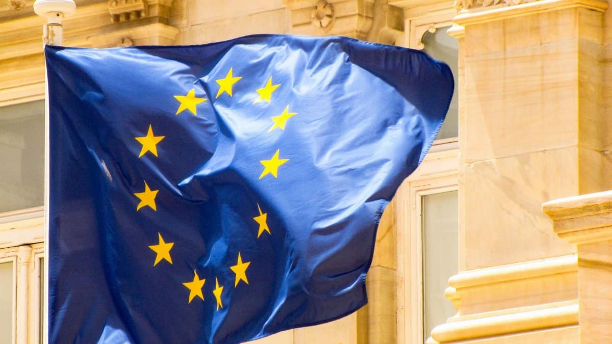 Bright European Union flag waving against historic architecture in Cartagena, Spain.