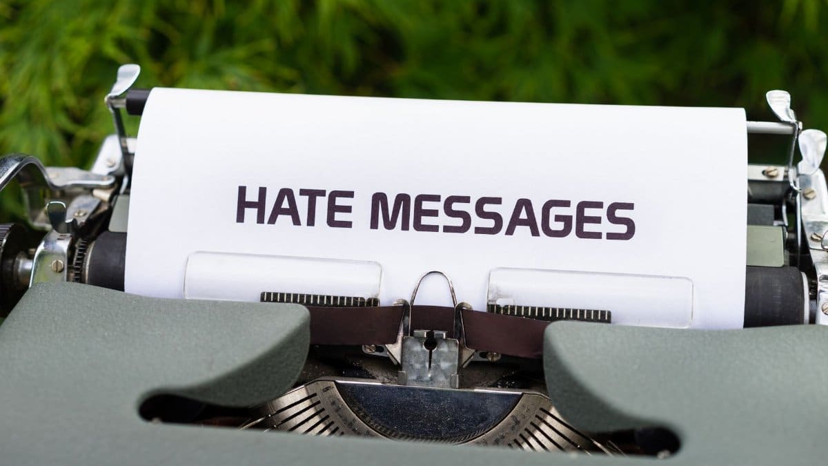 Close-up of a vintage typewriter with paper displaying 'Hate Messages', exploring themes of communication and negativity.