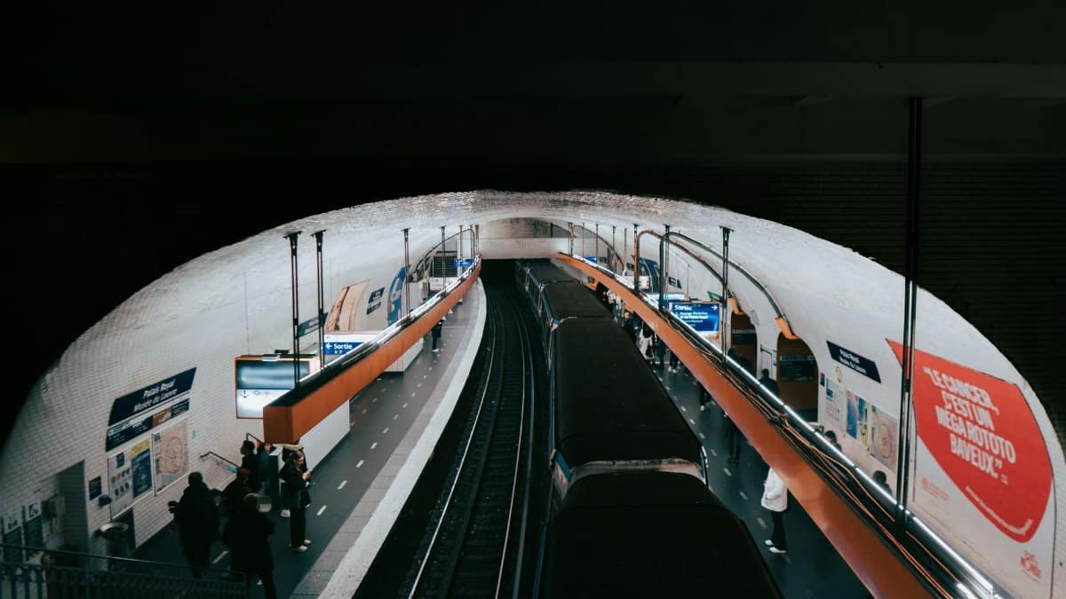 A busy Paris metro station captured with commuters waiting for their train.