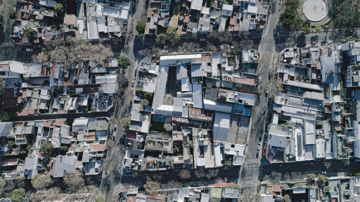 Aerial view of a dense urban neighborhood featuring various residential buildings and streets.