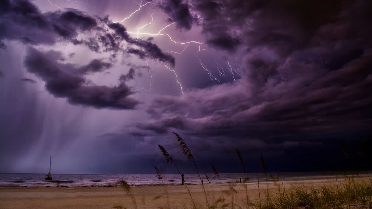 Dramatic lightning bolts illuminate the night sky over Redington Beach, creating a stunning natural scene.