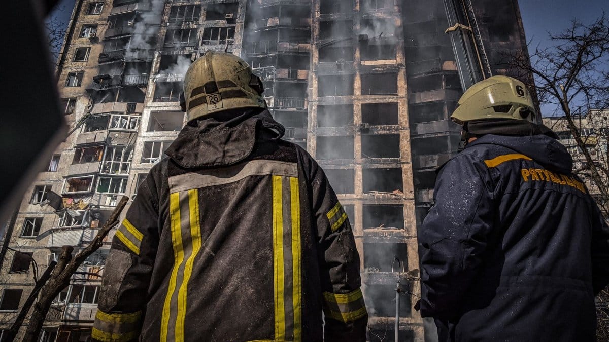 Firefighters in protective gear battle a blazing high-rise fire in Kyiv, Ukraine.