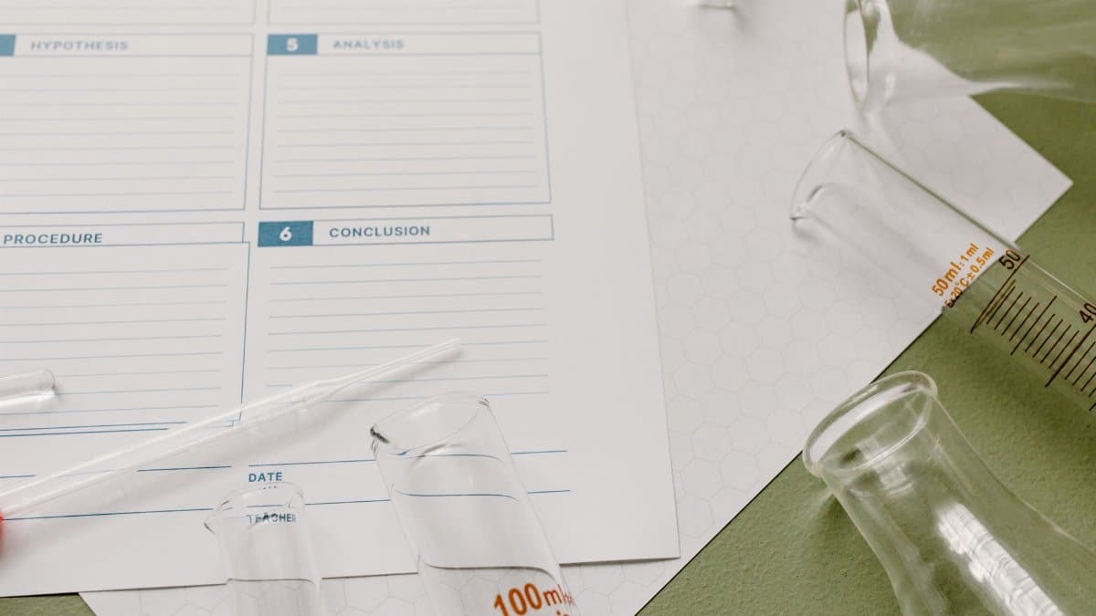 Top view of laboratory glassware and a scientific form for research documentation.