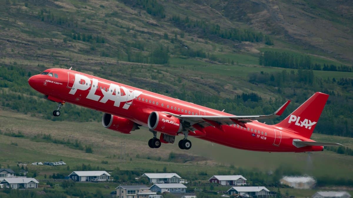 Play Airline Airbus A321 Neo takes off over Icelandic landscape, showcasing aviation and travel.