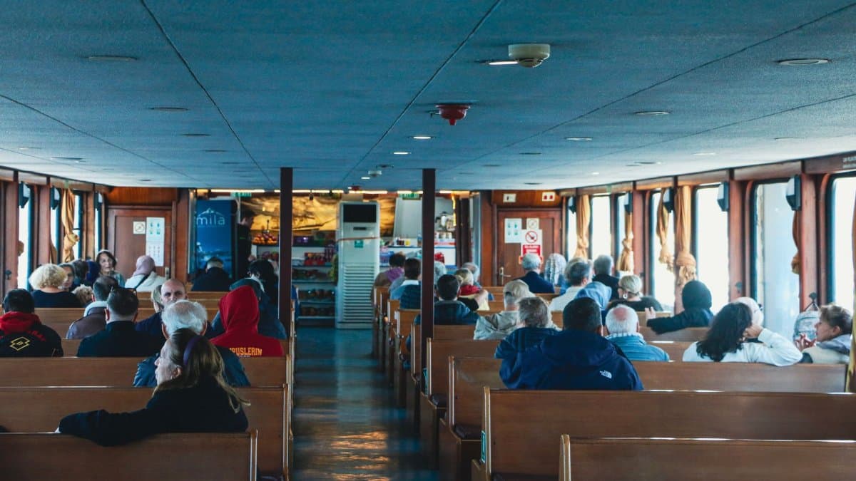 Passengers seated inside a ferry boat in İstanbul, enjoying a serene journey across the waterways.