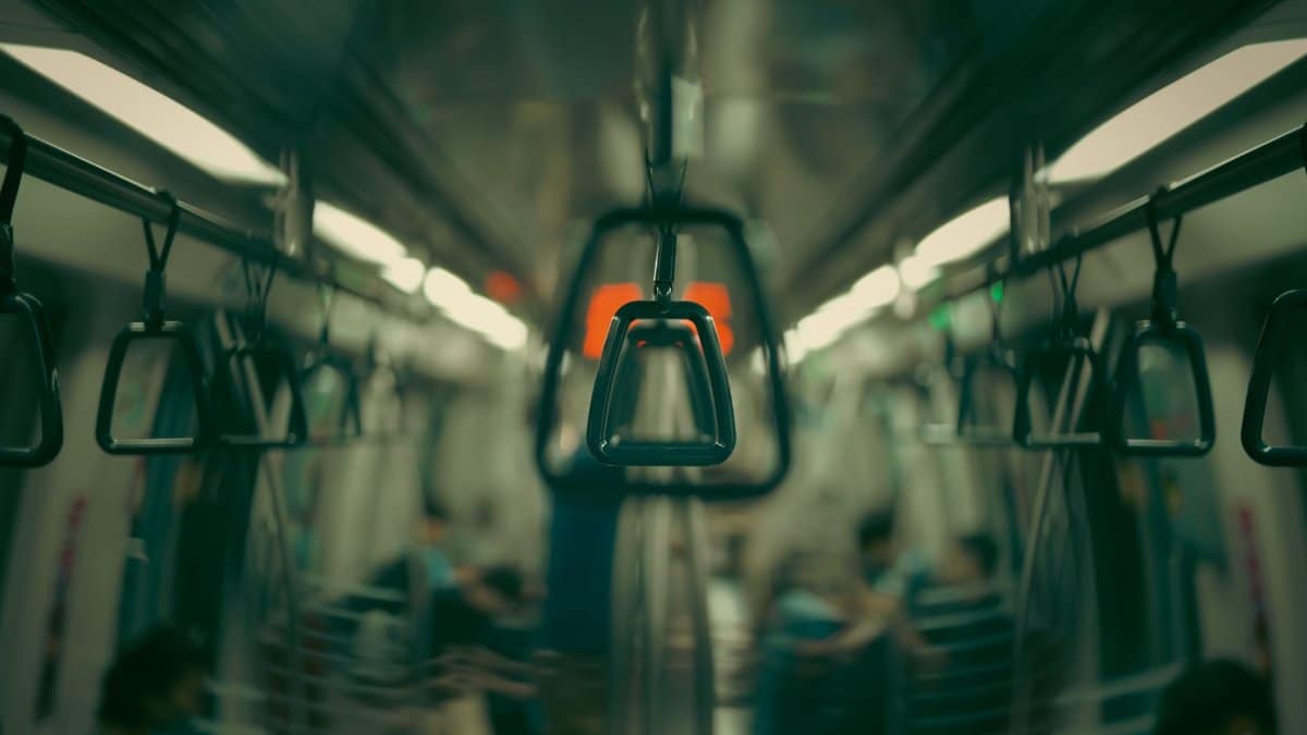 An artistic view focusing on hanging handles inside a public transportation train.