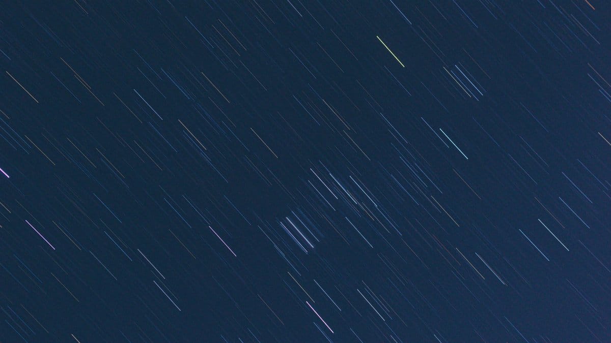 Long exposure shot capturing star trails creating stunning patterns in the night sky.