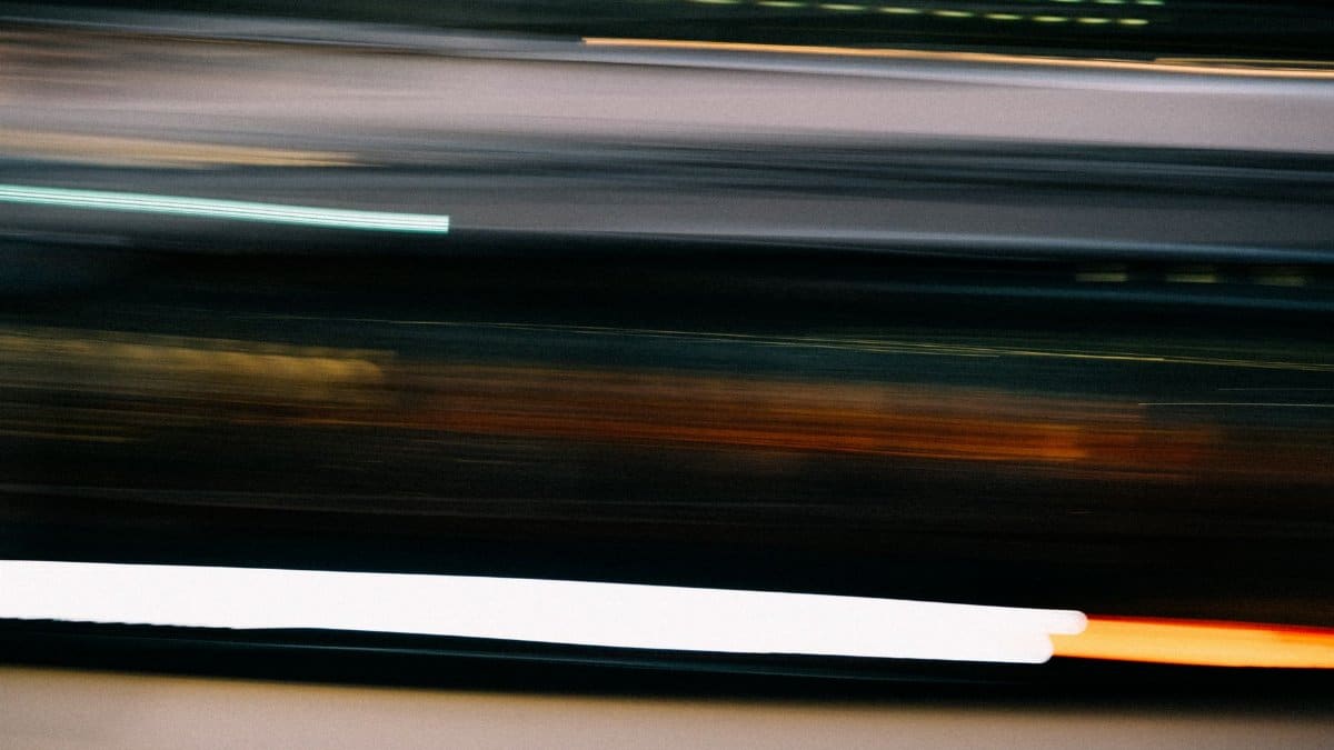 Blurred light trails captured at night, showcasing dynamic movement and abstract patterns.