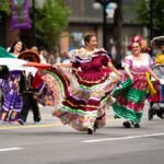 Vibrant Mexican cultural parade with traditional dresses in Victoria, BC streets.