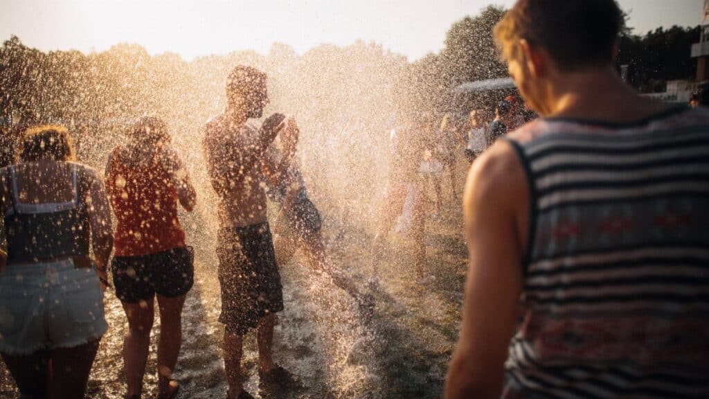 People enjoying water spray at a summer music festival in Budapest, Hungary.