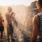 People enjoying water spray at a summer music festival in Budapest, Hungary.