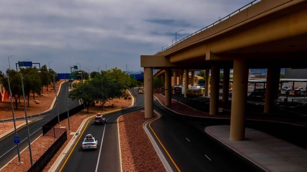 An urban highway scene with overpass and vehicles on a cloudy day, featuring road infrastructure.