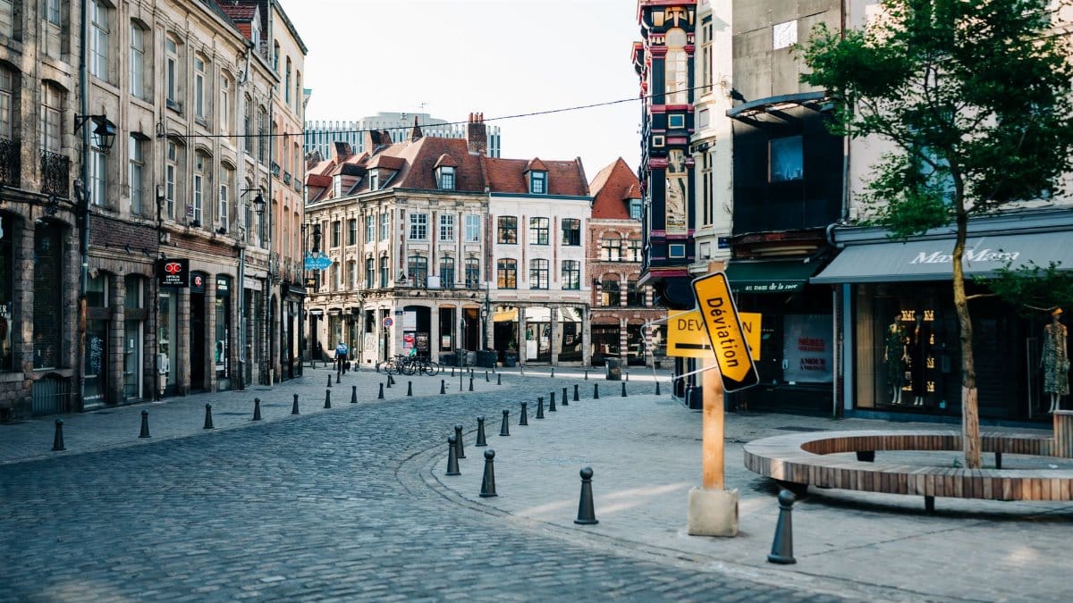 Explore the quaint cobblestone streets of Lille, France, showcasing historic townhouses and local landmarks.