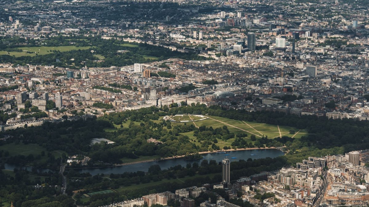 A stunning aerial view of London's skyline featuring lush parklands and urban architecture.