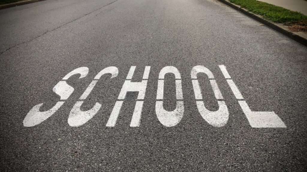 Close-up of 'School' road marking in a school zone, Zelienople, PA.