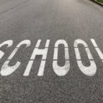 Close-up of 'School' road marking in a school zone, Zelienople, PA.
