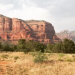 Explore the stunning red rock formations of Sedona, Arizona under the bright summer sky.