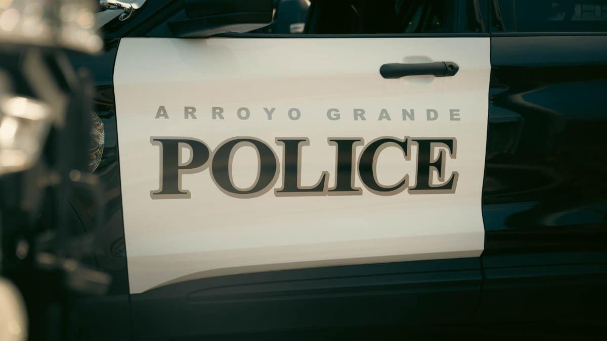 Close-up view of Arroyo Grande Police car door, showcasing bold text and design.