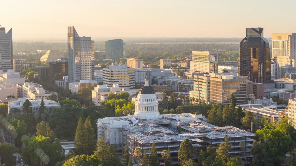 Aerial view of Sacramento cityscape featuring the California State Capitol at sunset.