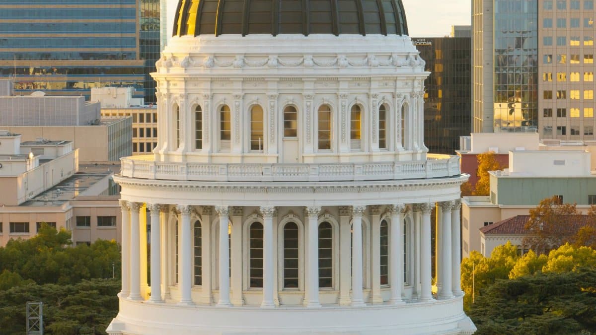 Majestic view of the California State Capitol Dome in Sacramento during sunset with clear skies.