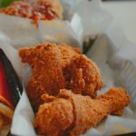 Close-up of crispy fried chicken and fries in a fast food restaurant.