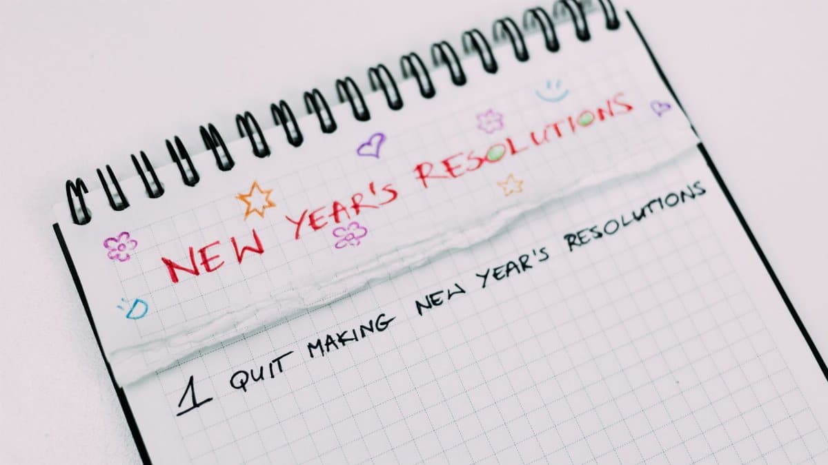 A notebook page with handwritten New Year's resolutions in colorful text.