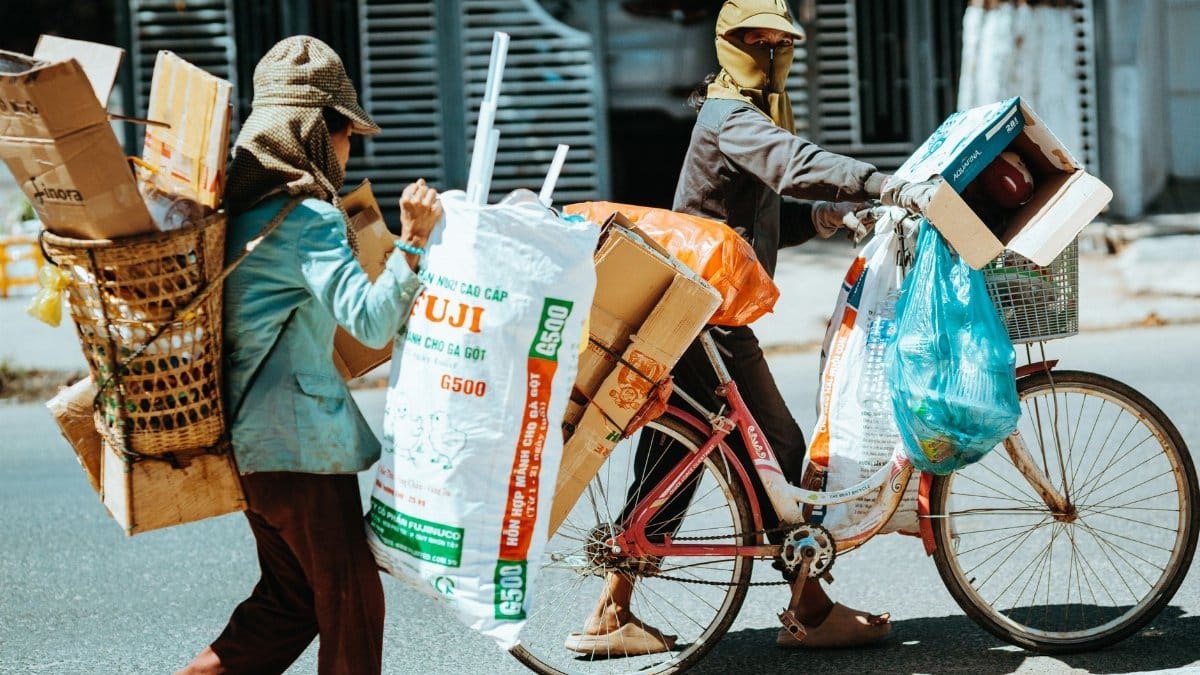 Street vendors in Vietnam recycle items on a busy street, capturing local life.
