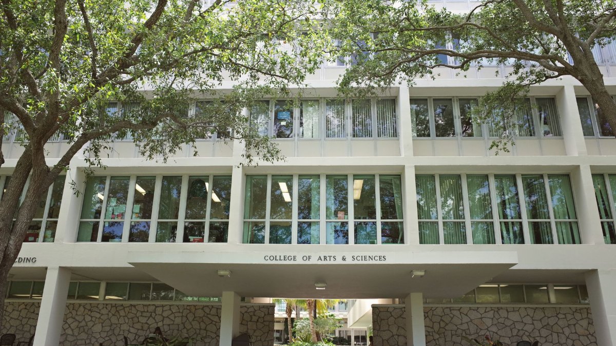 College of Arts & Sciences building at University of Miami, surrounded by lush trees.