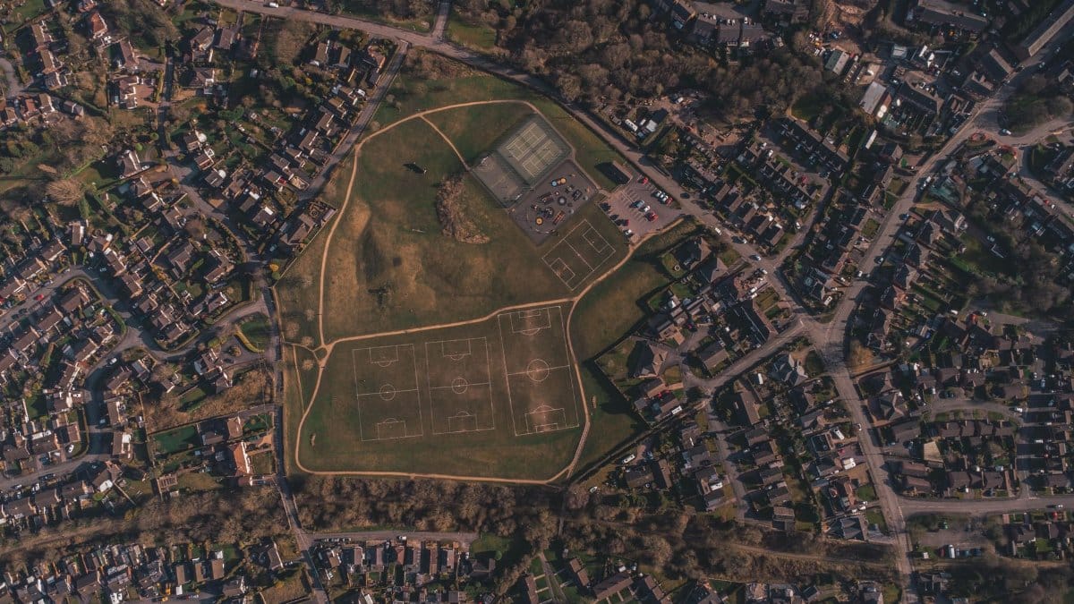 Aerial view of suburban soccer fields surrounded by residential houses.