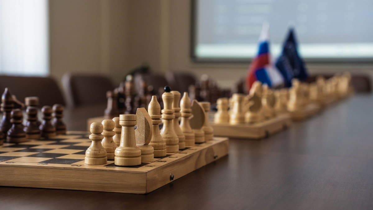 A detailed view of a chess board setup in a professional meeting room, highlighting strategy and planning.